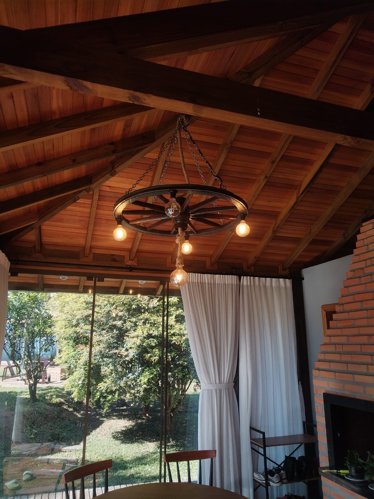 Área gourmet com lustre rústico e iluminação ambiente
